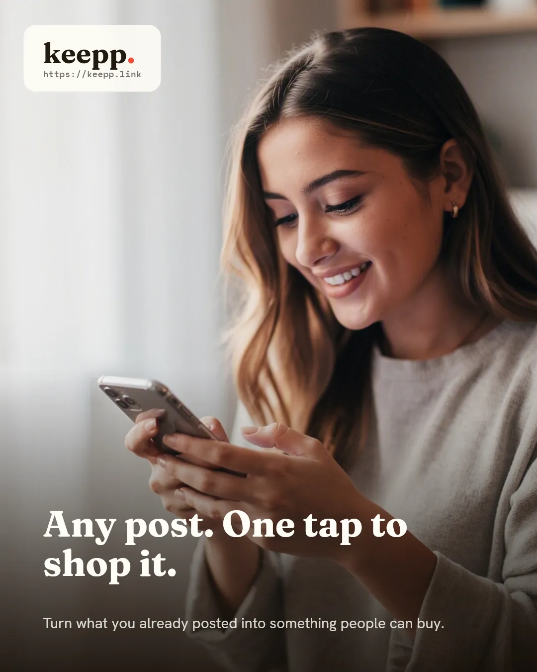 A young woman glancing down at her phone with a small pleased smile