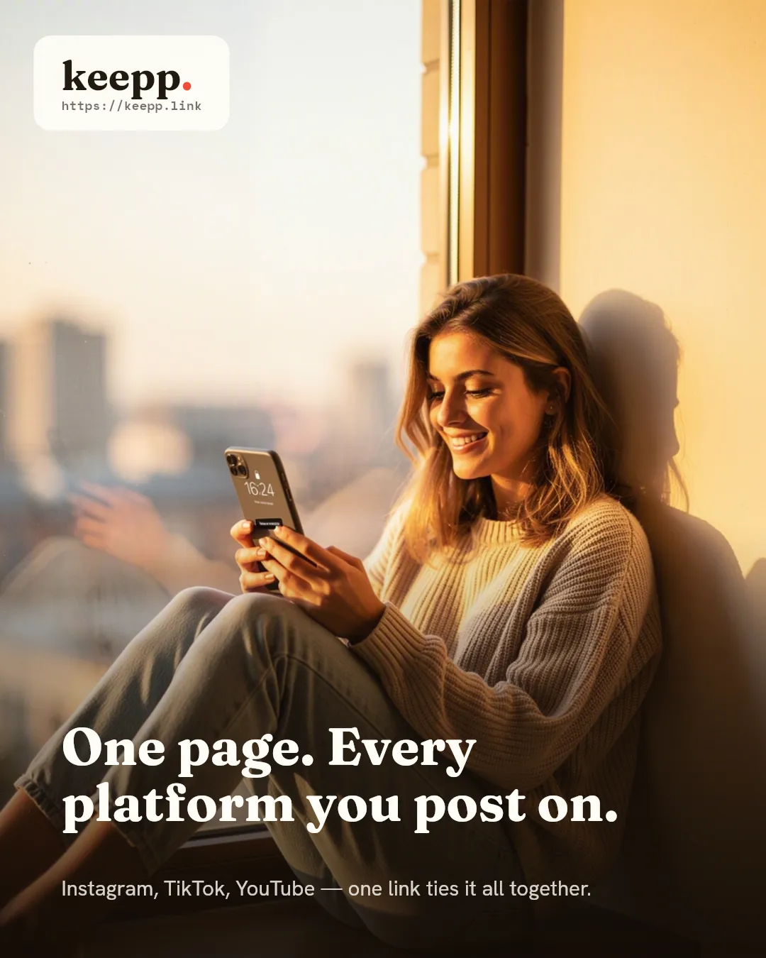 A woman sitting on a windowsill reading her phone in warm afternoon light